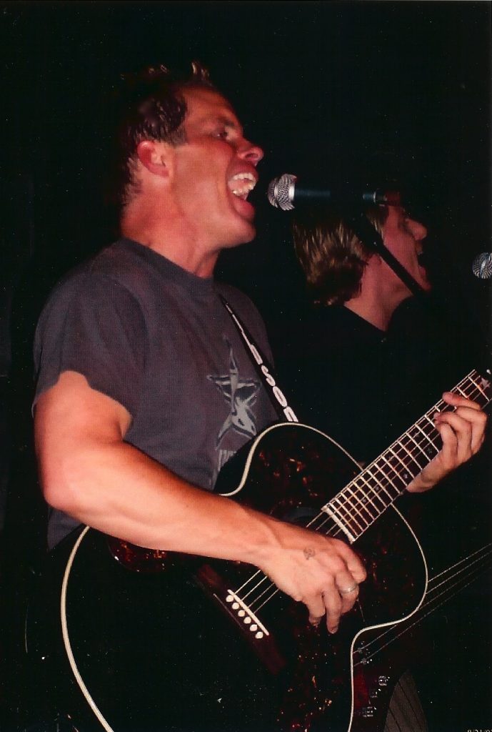 Josh Canova playing guitar and singing